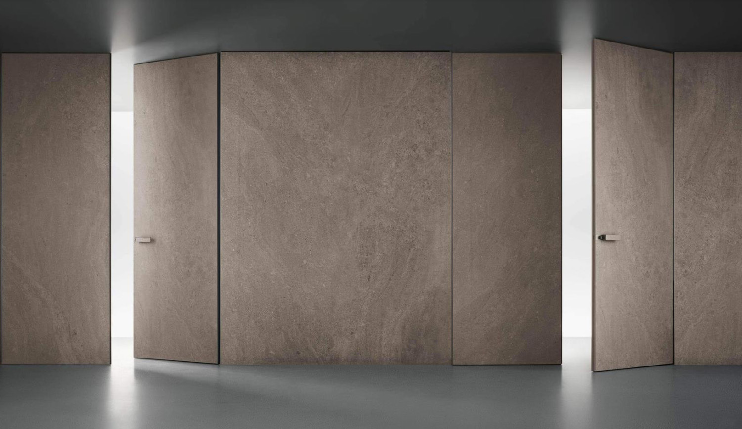 Aluminium-wood invisible doors aligned with a continuous panelled wall