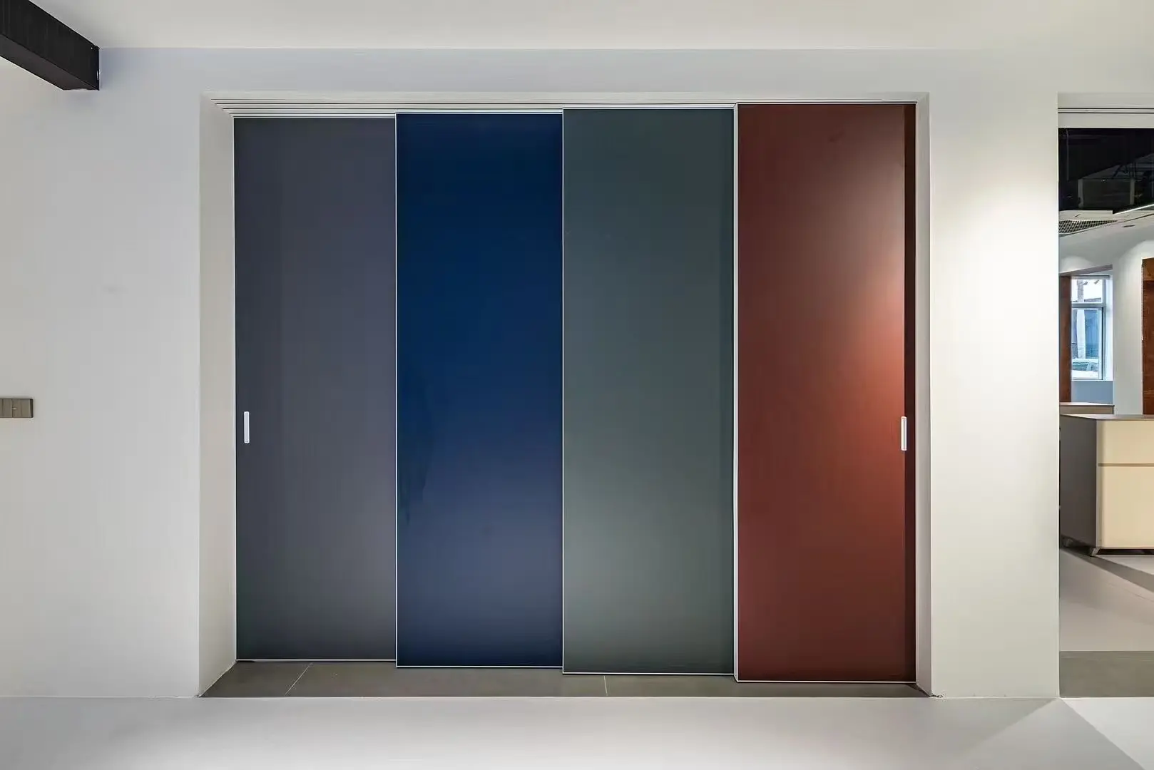 Four contrasting solid panels in a multi-track sliding door display