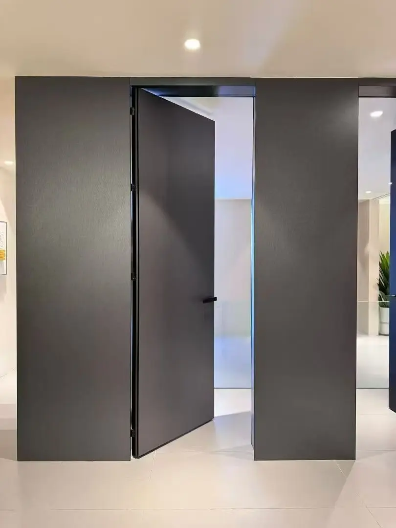 Dark panel-ready invisible door shown open in an integrated wall