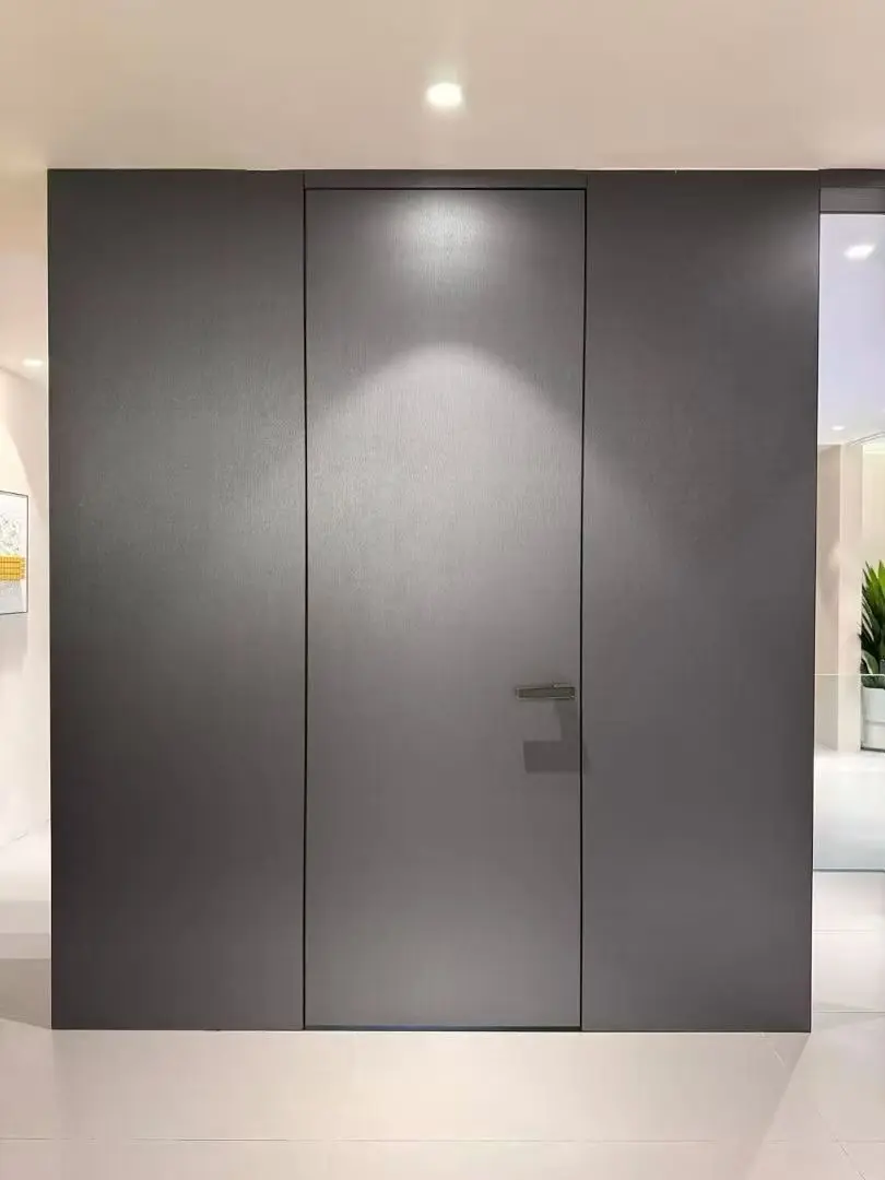 Dark panel-ready invisible door closed flush with the wall