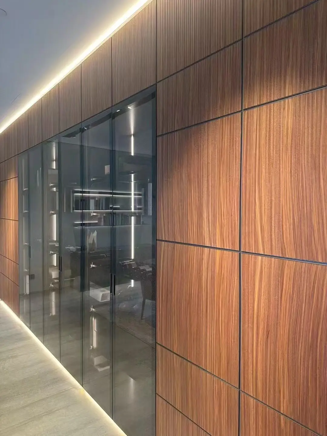 Timber panel wall with full-height glazed display cabinets
