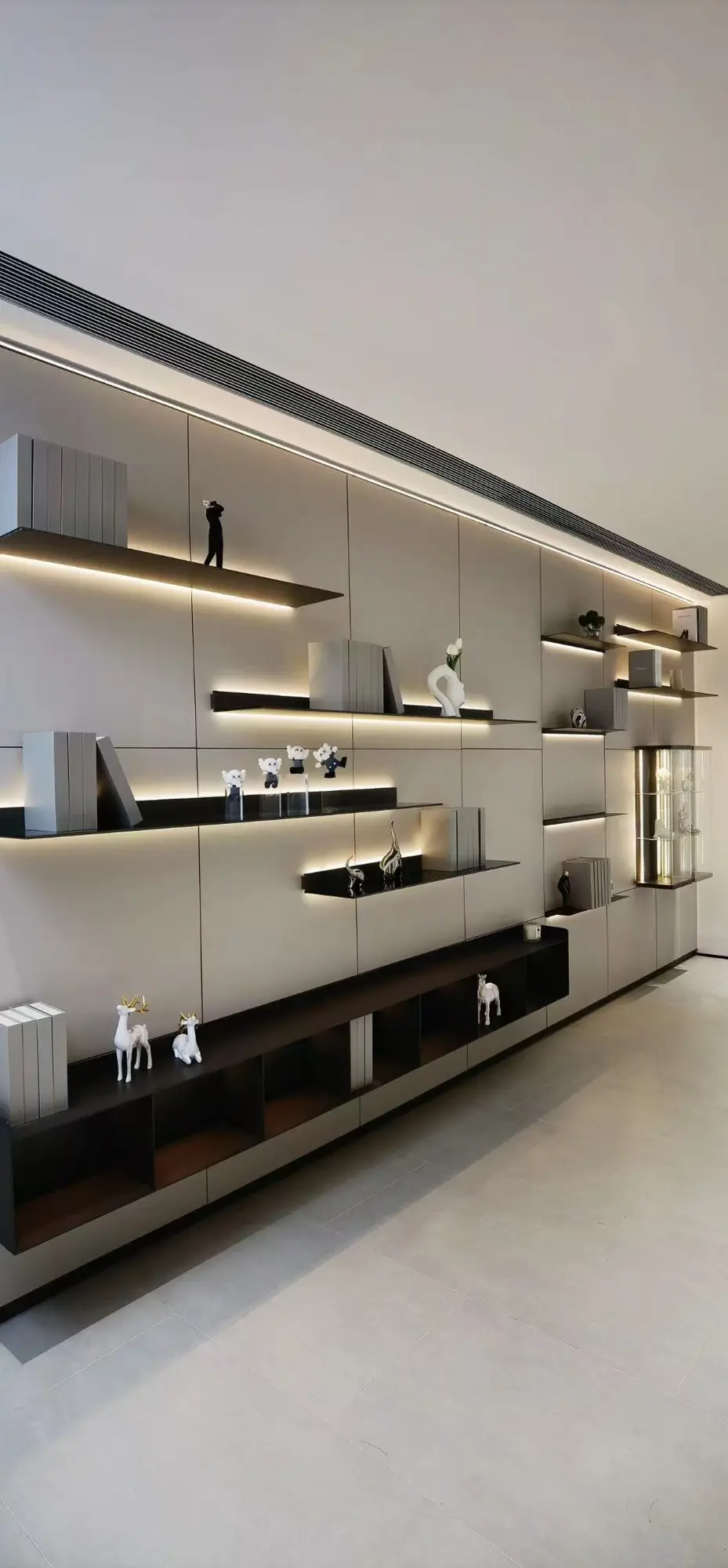 Full-height equipped wall with illuminated floating shelves and cabinets
