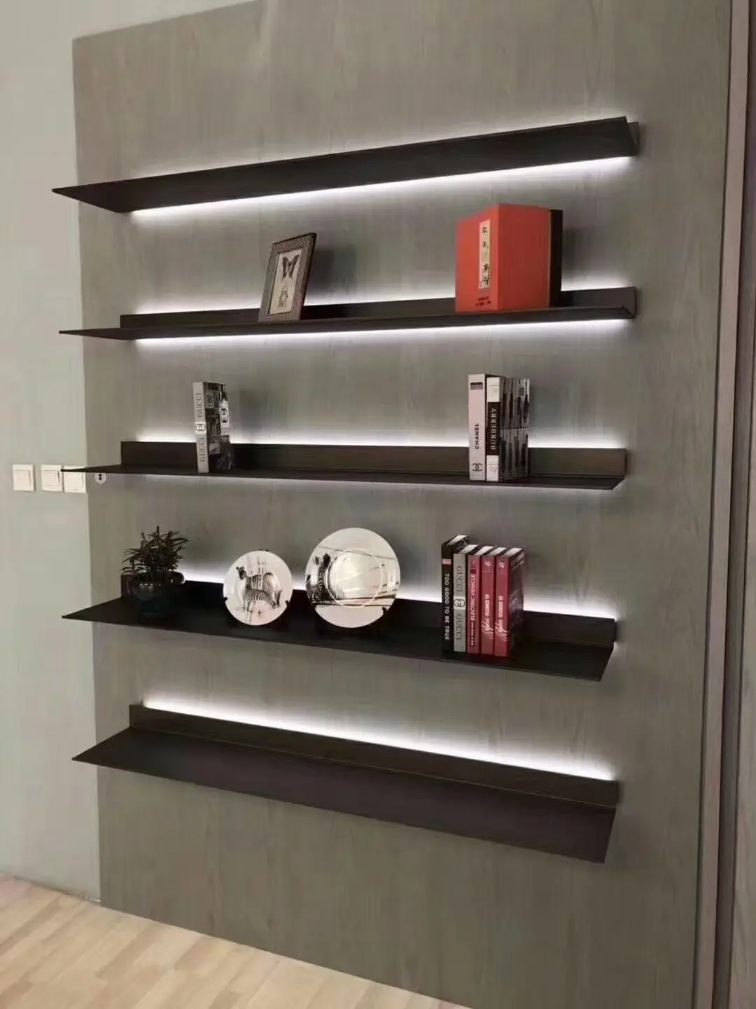 Wall-mounted metal display shelves with integrated backlighting
