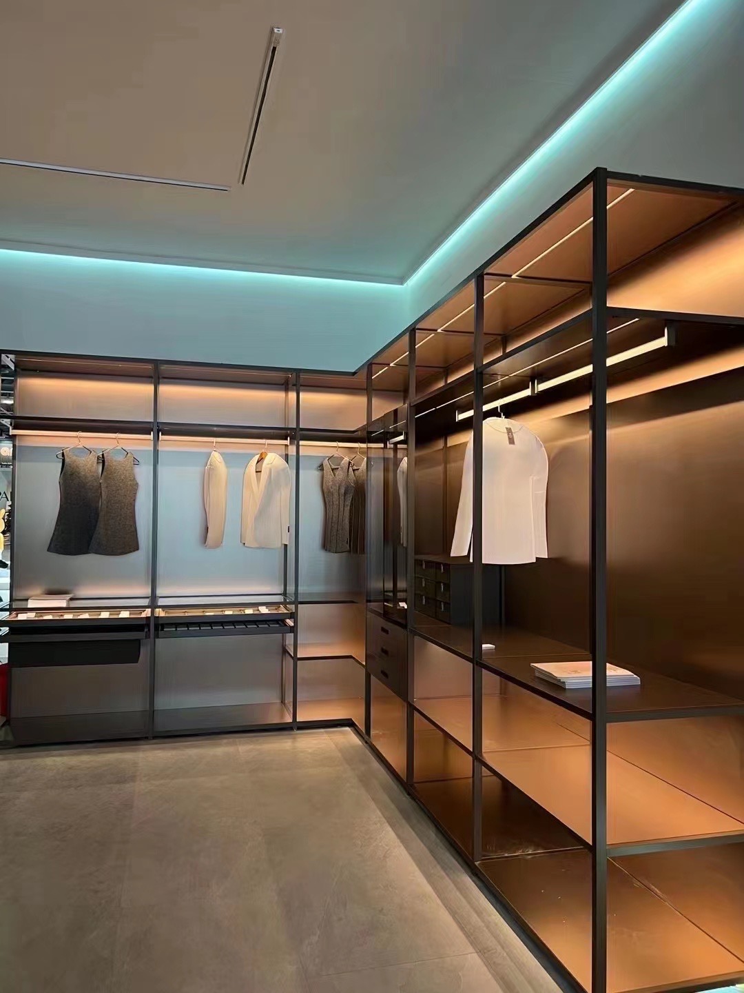 Illuminated open wardrobe arranged around a dressing room