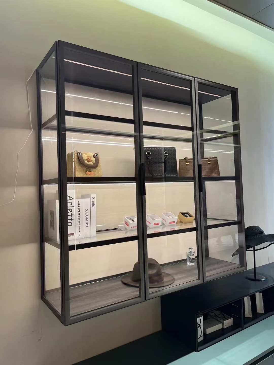 Wall-mounted three-door illuminated glass display cabinet