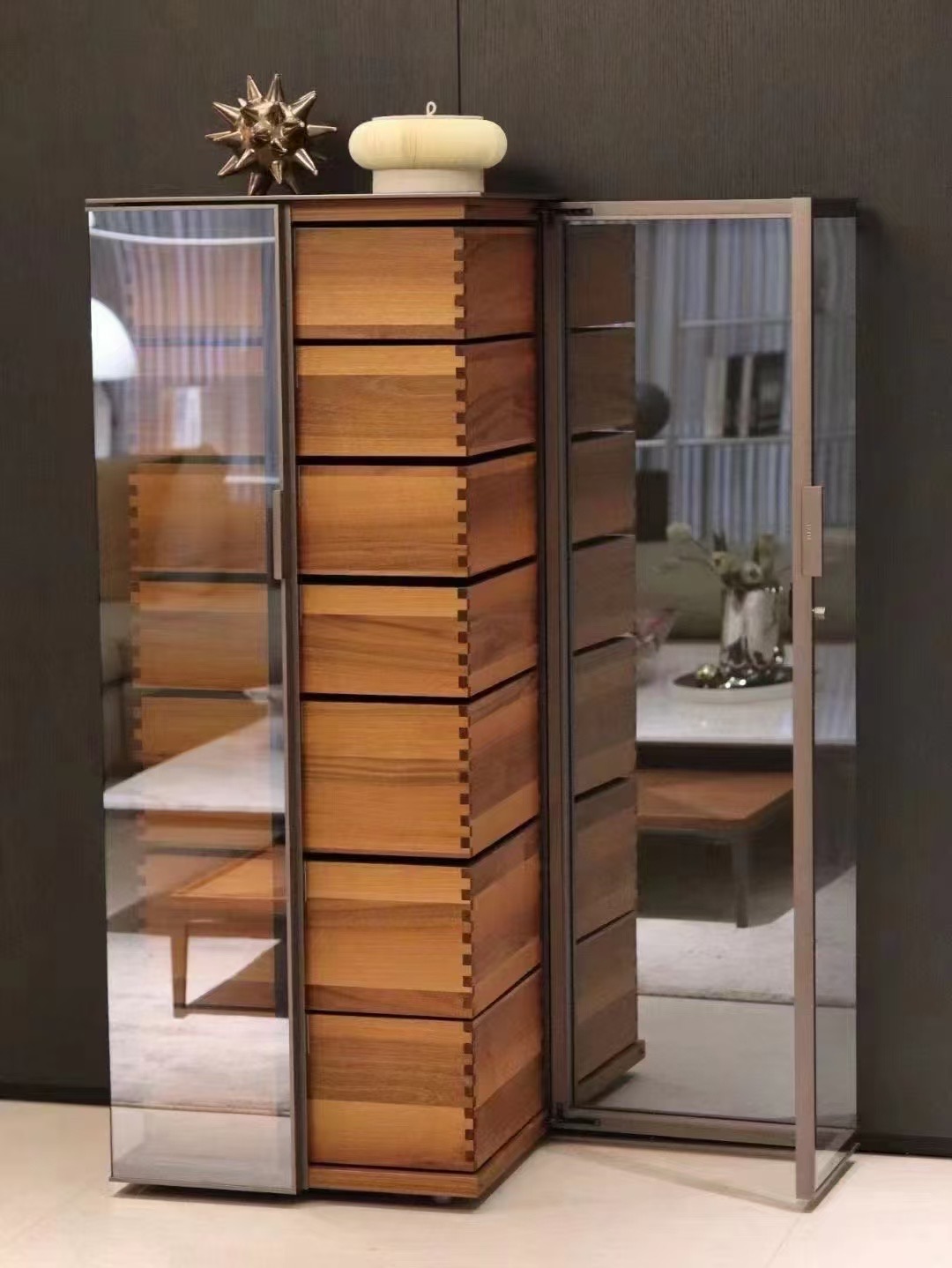 Illuminated timber drawer tower inside a glass cabinet
