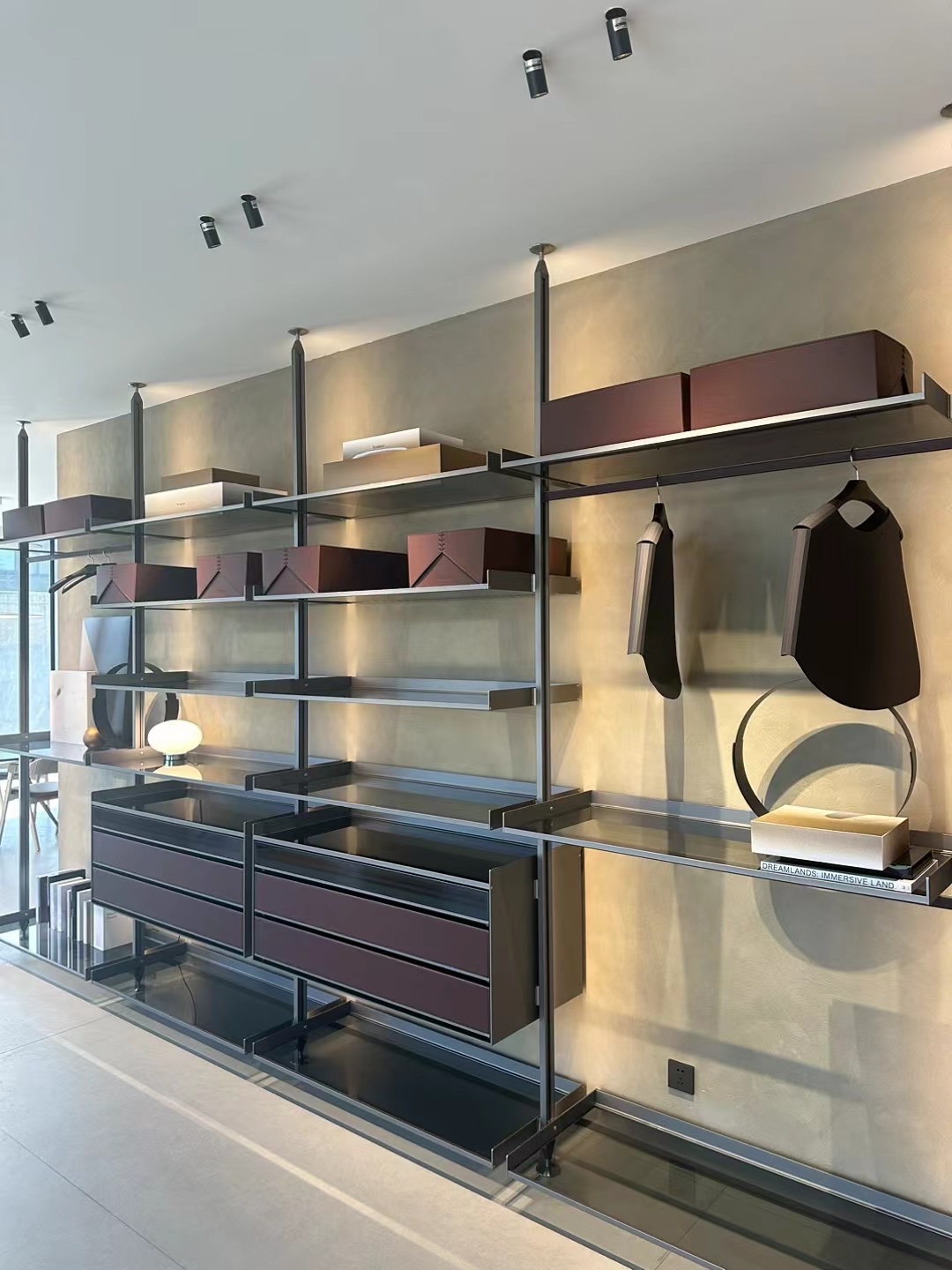 Floor-to-ceiling retail wall system with rails and drawers