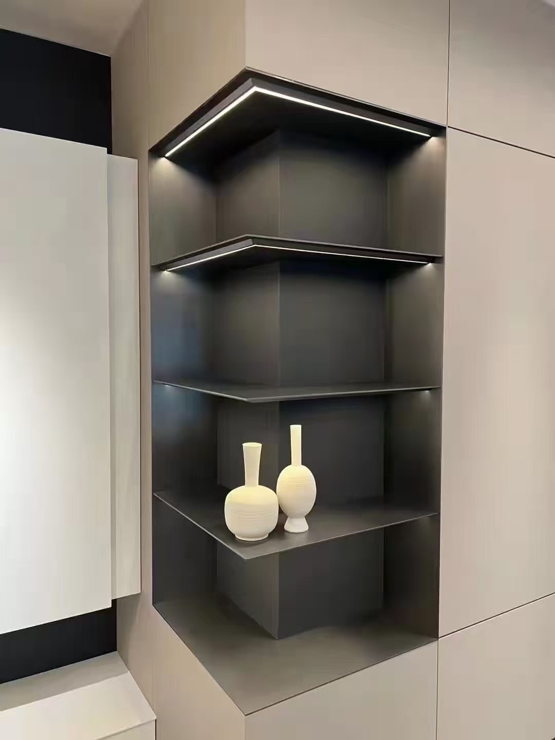 Dark inset display shelves with integrated perimeter lighting