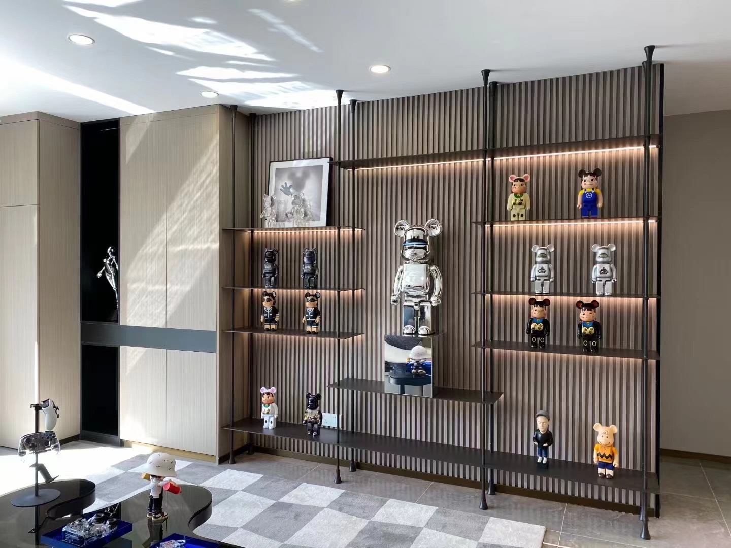 Illuminated modular display wall for a residential collection