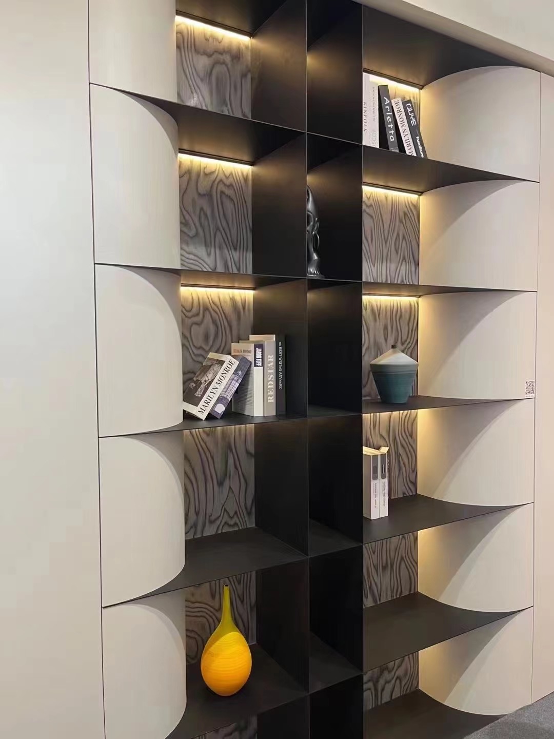 Curved cabinet fronts framing illuminated display niches