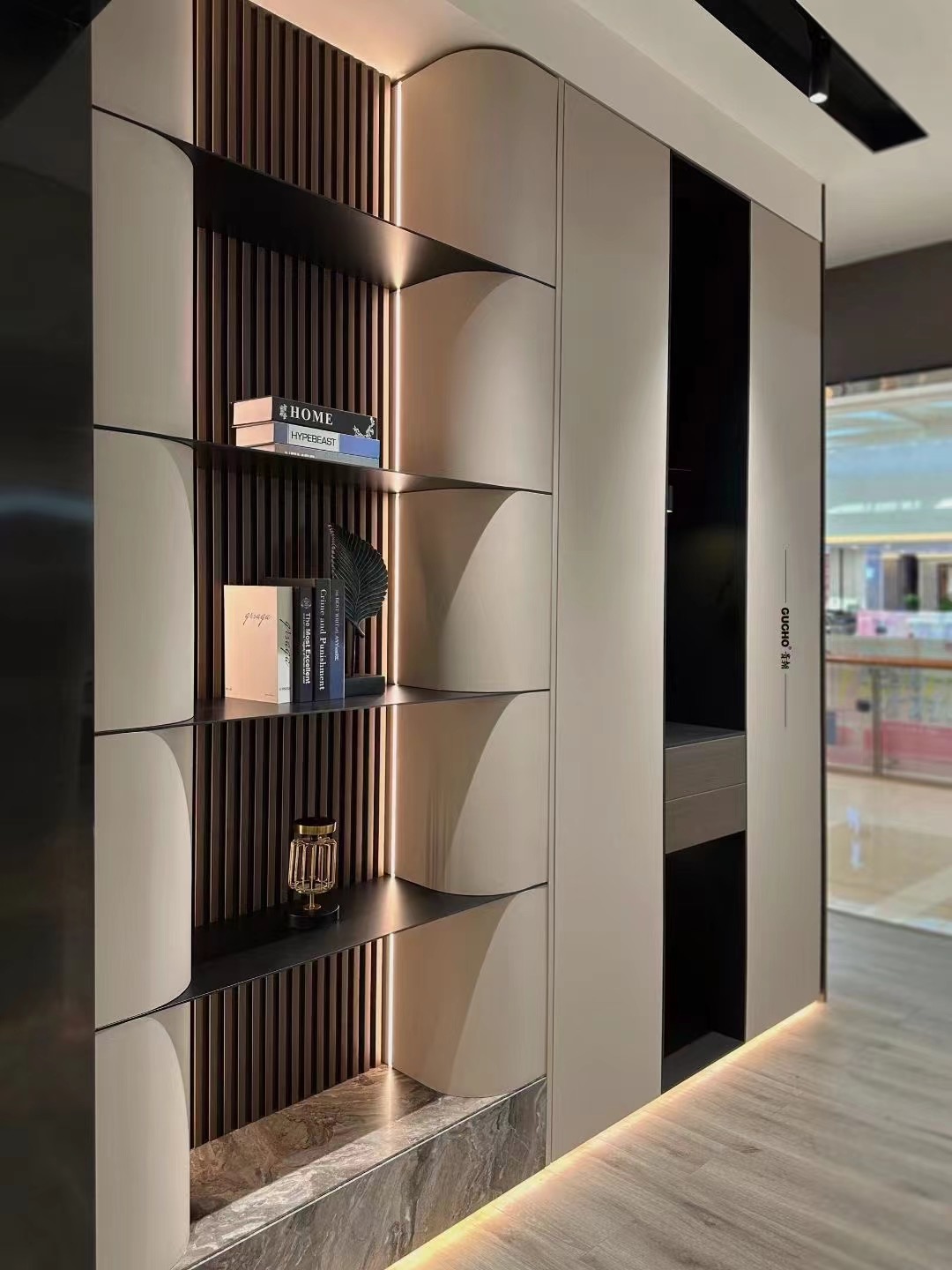 Integrated curved wall cabinet with open display shelves