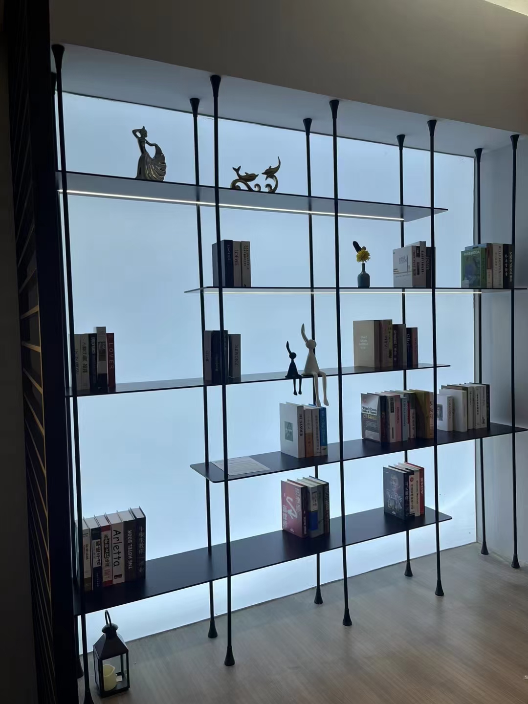 Backlit open shelving across a full-height window